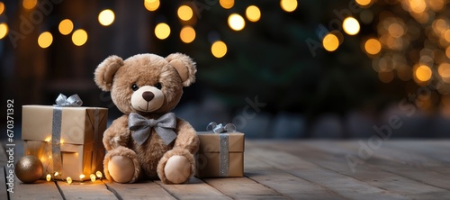 A wide-format Christmas-themed background image with a teddy bear seated beside presents in a snowy forest scene, allowing for customization to craft a festive ambiance. Photorealistic illustration