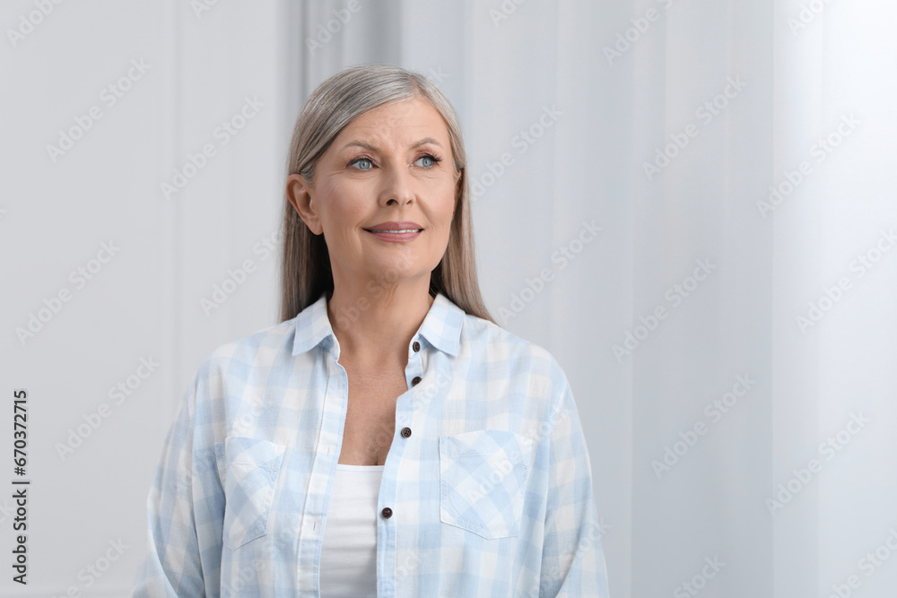 Portrait of beautiful senior woman indoors. Space for text Portrait of beautiful senior woman indoors. Space for text