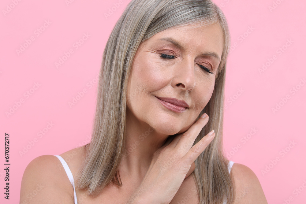 Portrait of beautiful senior woman on pink background Portrait of beautiful senior woman on pink background