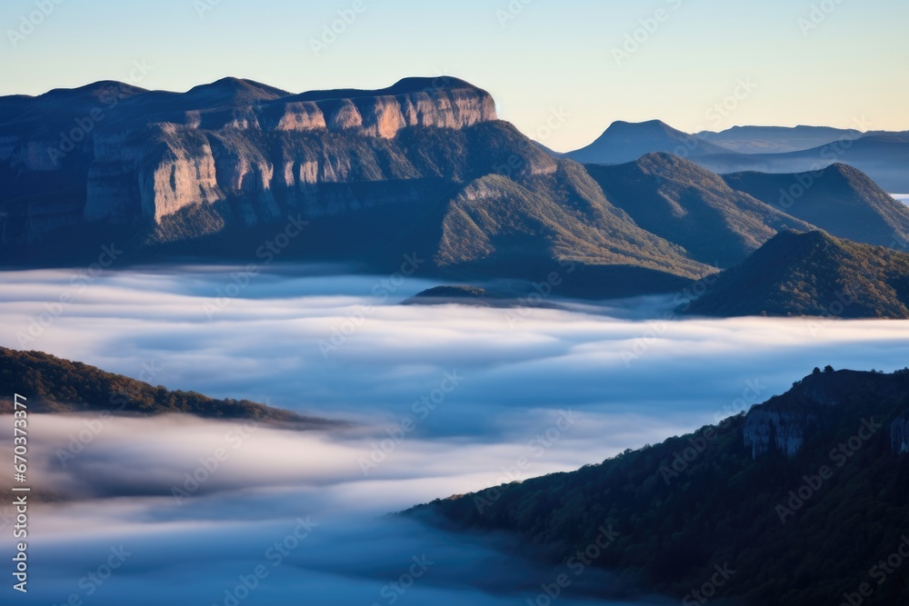 mountains shrouded in fog at dawn