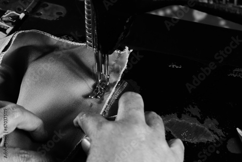 Vintage Black and White Close up Senior Female Tailor Sewing batik indonesian fabric into cloth, elder senior and vintage black and white concept