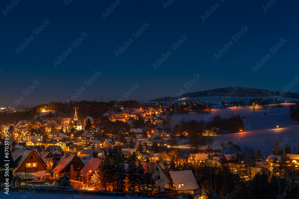 Illuminated houses in Seiffen at Christmastime. Saxony, Germany
