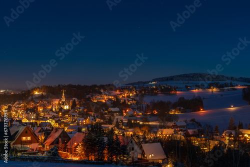 Illuminated houses in Seiffen at Christmastime. Saxony, Germany photo
