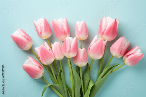 Beautiful bouquet of pink tulips against vibrant blue background. Perfect for springtime designs and floral themes.