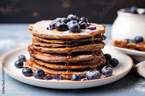 a stack of vegan pancakes topped with blueberries