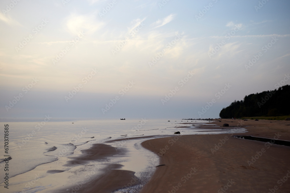 Amazing calm scenery of a blue sky and tranquil sea with light fog above, selective focus