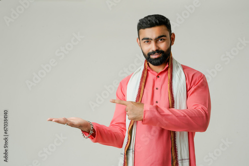 Young indian farmer giving expression on white background.