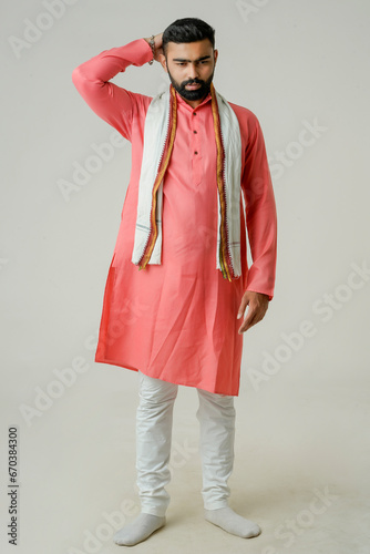 Young indian farmer giving expression on white background.