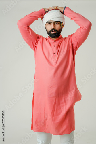 Young indian farmer giving expression on white background.