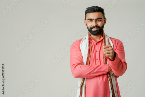 Young indian farmer giving expression on white background.