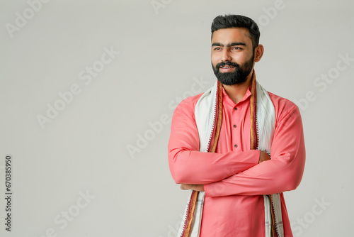 Young indian farmer giving expression on white background.