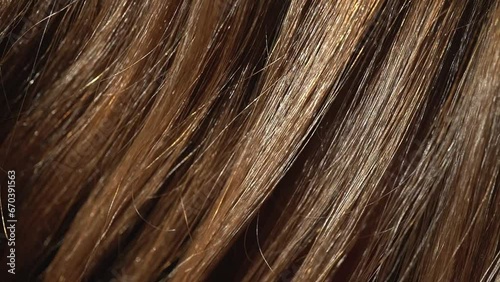 Beautiful healthy long wavy flowing brown hair close up. Dyed natural hair, coloring, extensions, treatment. Hair care. photo
