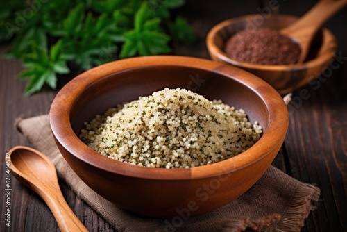 cooked quinoa in an earthen bowl with a wooden spoon © altitudevisual