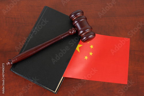 Wall Mural Wooden judge gavel and legal book with flag of China on wooden table