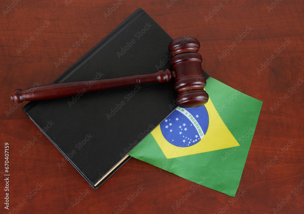 Judge gavel on legal book with flag of Brazil