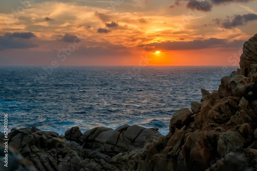 Scenic view of a rocky coastal scene in Sardegna  Italy at sunset.