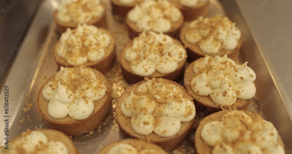 The process of making mini tarts. Sprinkle and decorate mini tarts with grated nuts. The process of making mini tarts. Sprinkle and decorate mini tarts with grated nuts.