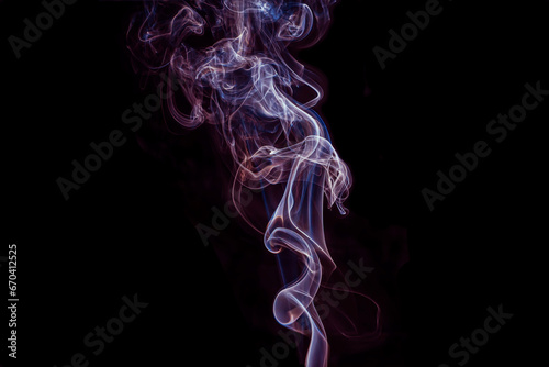 The steam color smoke of in movement on a black background. It is abstract.