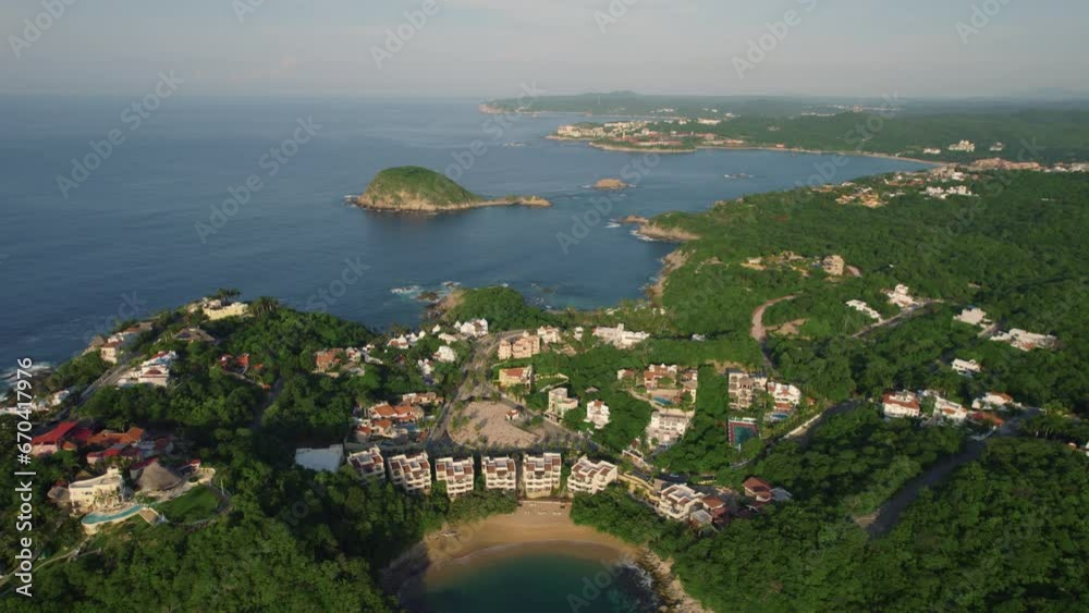 Huatulco coast: serene bays, lush hills, and coastal homes, Mexico - aerial Huatulco coast: serene bays, lush hills, and coastal homes, Mexico - aerial