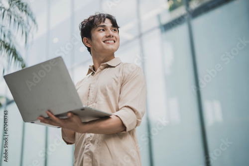 Photo of young Asian business people working outdoor