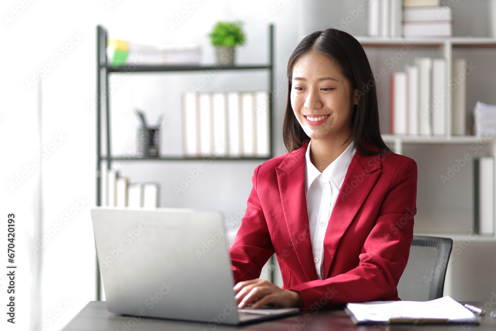 Businesswoman working on documents on laptop on desk in office. Businesswoman working on documents on laptop on desk in office.