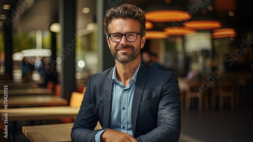 Portrait of young businessman wearing eyeglasses and standing outside conference room. Portrait of happy business man wearing spectacles and looking at camera. Generative AI art © tanyastock