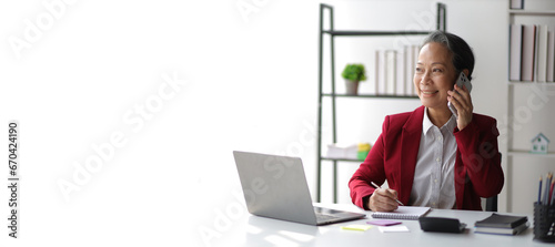 Portrait of senior business woman working in executive office.
