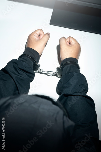 The man with tied hands in handcuffs