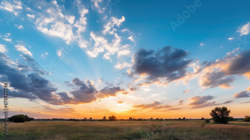 Sunset with fluffy clouds over rural landscape