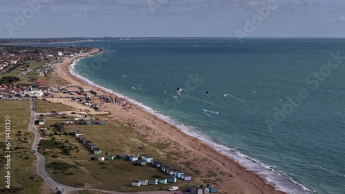 Drone footage of the kitesurfers and beach huts on Hayling Island shore on a sunny day, England