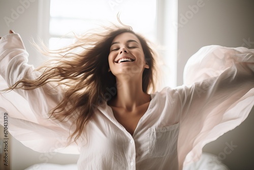 Pretty young woman in modern apartment stretching after wake up