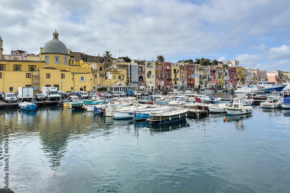 Idyllic marina scene of Procida Marina Grande port in Campania, Italy with fishing boats