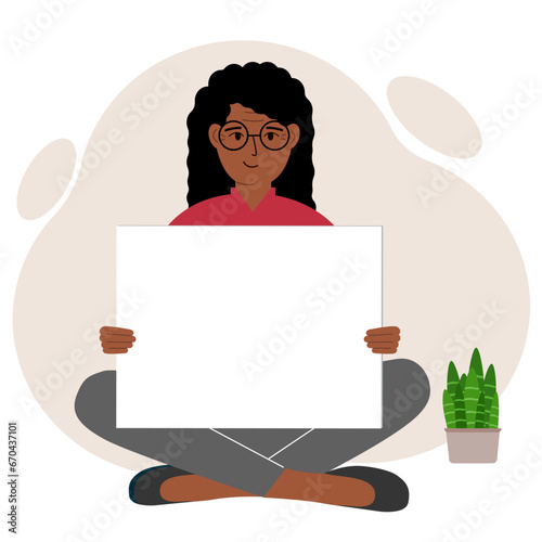 A woman sits cross-legged and holds a large white sheet with space for text. Advertising, poster, information, announcement.