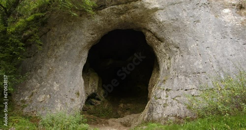 Mid shot of the dove hole cave on the dove Dale walk with tree in foreground photo