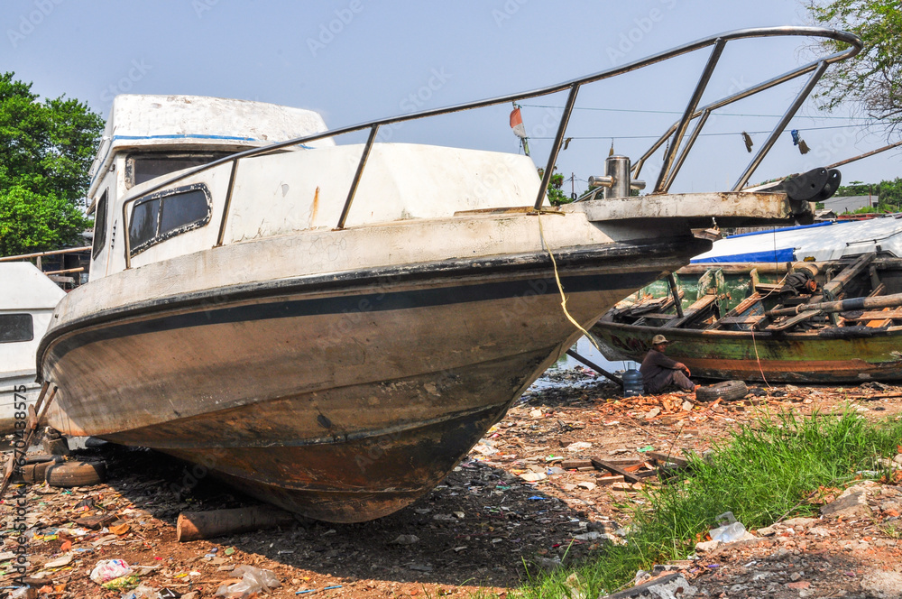 Jakarta, Indonesia – April 19, 2014: An old wrecked fishing boat Jakarta, Indonesia – April 19, 2014: An old wrecked fishing boat