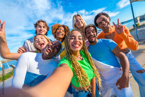 Multi-ethnic friends taking a selfie and smiling in the city