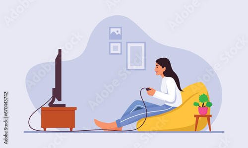 Girl playing video games while sitting on an ottoman at home