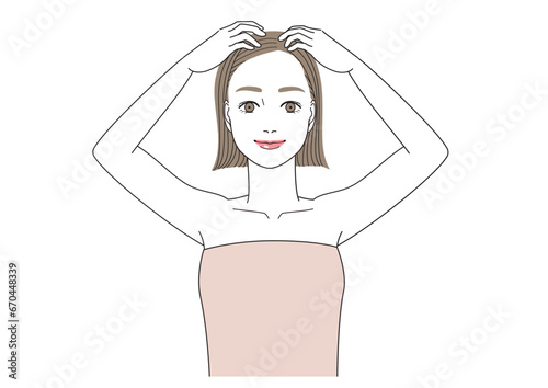 頭皮マッサージ　笑顔でと頭皮をマッサージしている女性