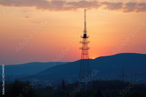 communication tower against sunset