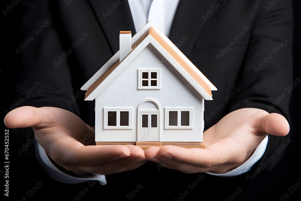 Hand with miniature house model, concept of real estate Hand with miniature house model, concept of real estate