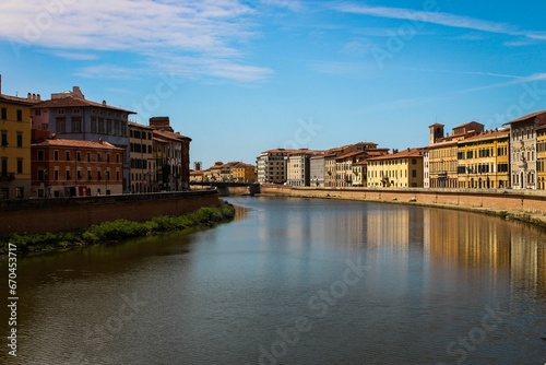 Picturesque view of a large body of water set against a backdrop of architecture in Pisa, Italy