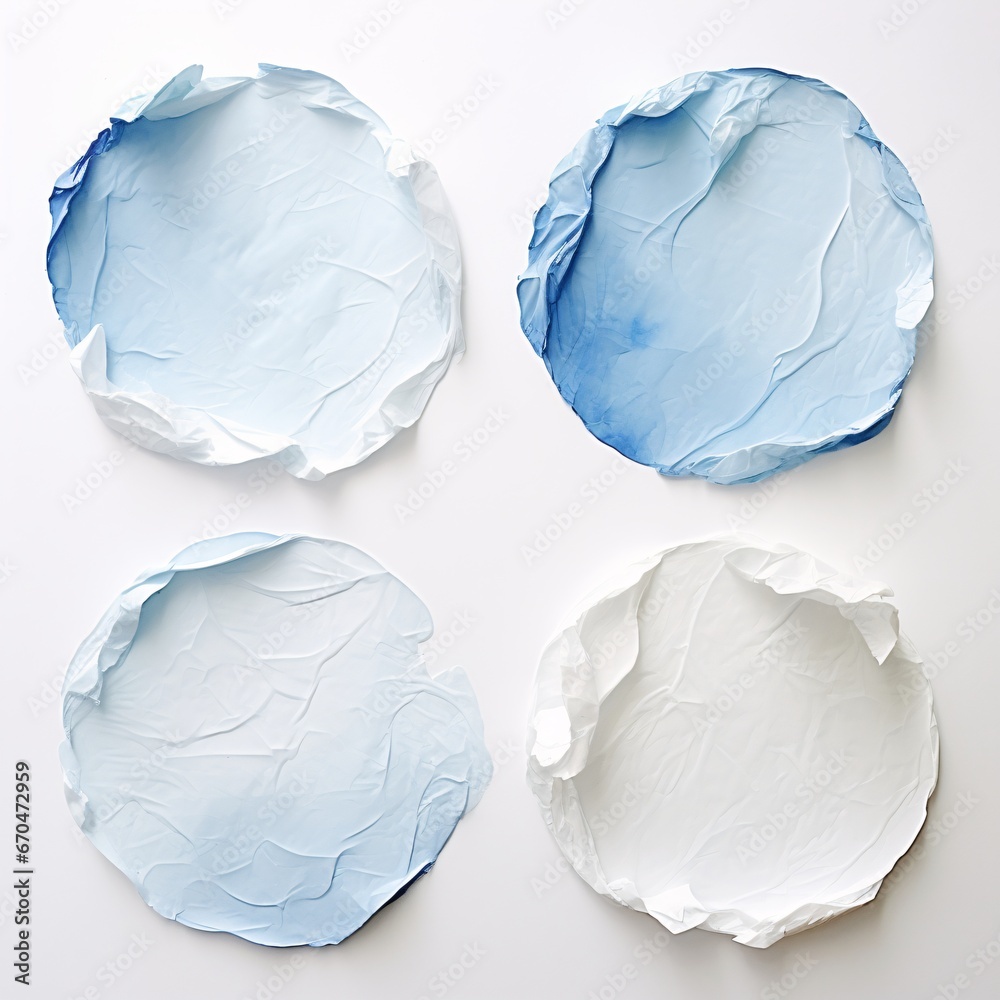 Naklejka premium four pieces of paper that have crumples and blue white spots on them on a white background, circular abstraction, light azure, light white and light azure four different sheets