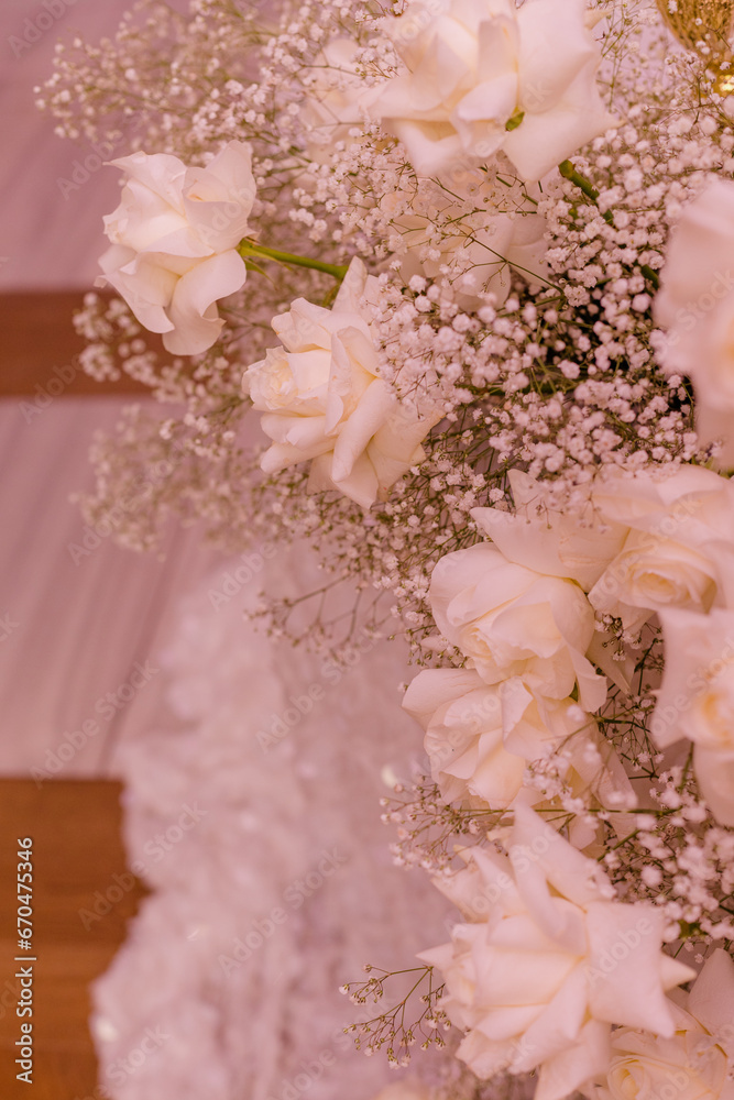 Fragment of luxurious floral arrangement of chic white roses and gypsophila at wedding ceremony. Fragment of luxurious floral arrangement of chic white roses and gypsophila at wedding ceremony.