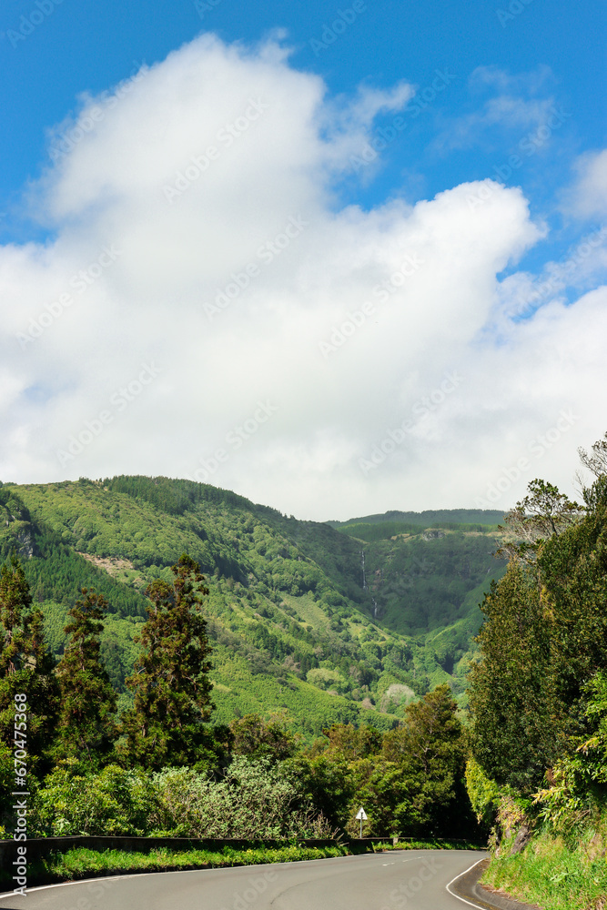 Obraz premium Island of Flores. Island of water. Portuguese Jurassic Park. High waterfall seen from a highway.