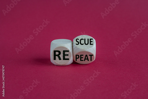 Concept words Rescue Repeat on wooden cubes. Beautiful red background. Business rescue and repeat concept. Copy space.