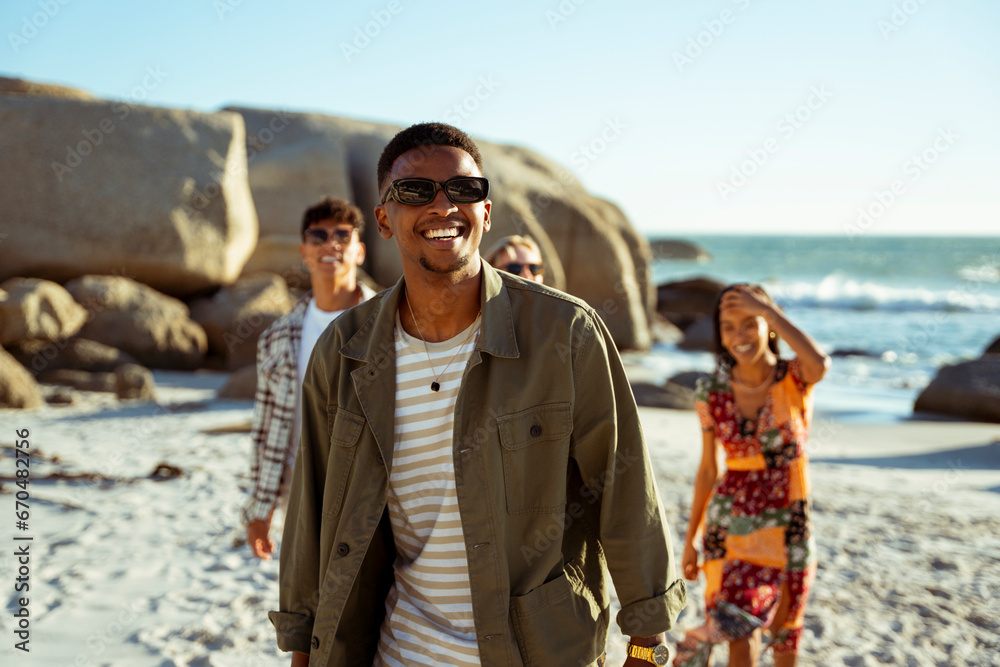 A Man Walking Towards the Camera on a Beach