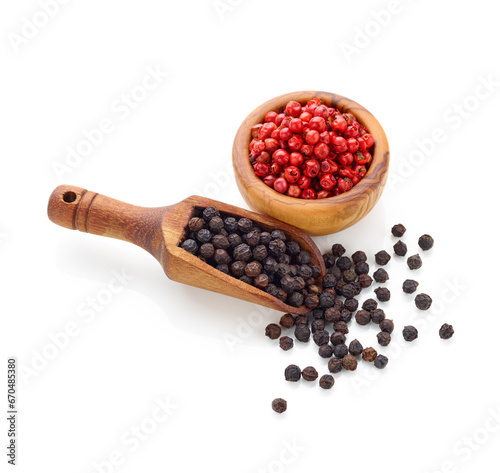 Black pepper in wooden spoon and peppercorn in wooden bowl isolated on white background