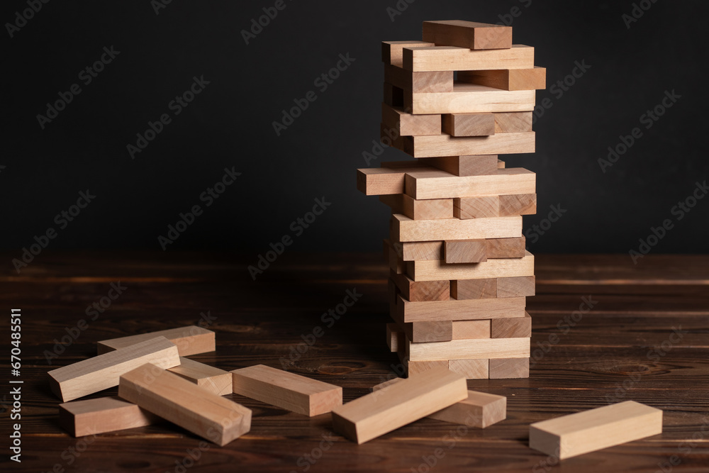 Jenga tower made of wooden blocks on wooden background, space for text Jenga tower made of wooden blocks on wooden background, space for text