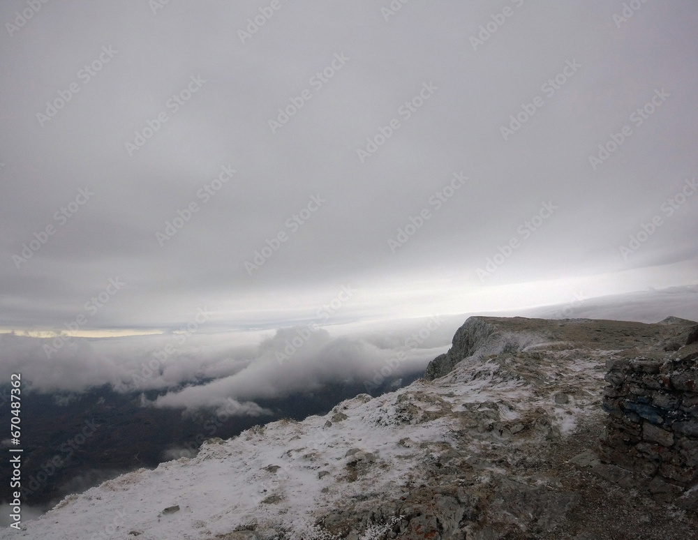 Panorama of a colored mountain landscape in Serbia with the snow covered mountains. Winter landscape. Mountain peak in clouds.