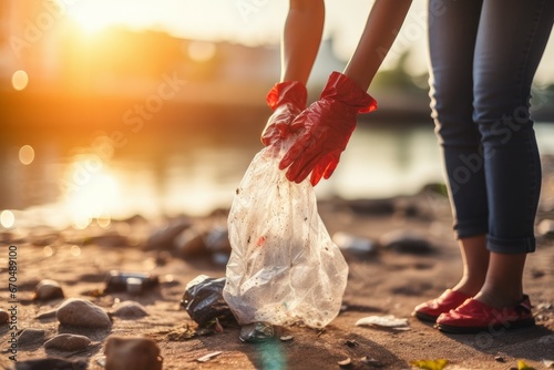 Woman with trash bag picking up plastic bottle at lake beach. Nature cleanup volunteer care. Generate Ai